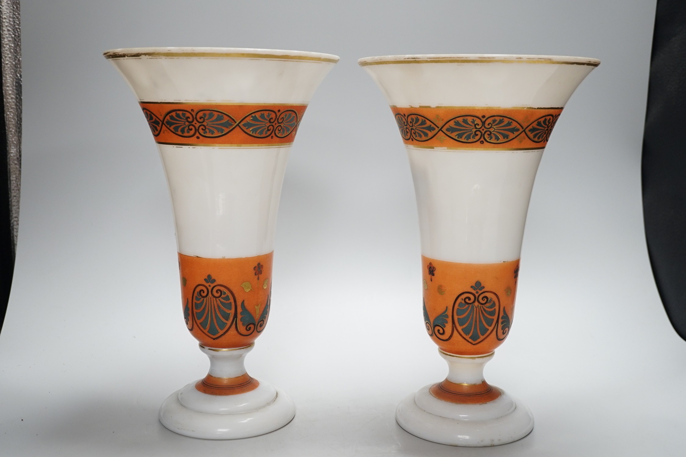 A pair of late 19th century French opaque glass ‘palmette’ vases, with orange decorative bands, 30cms high